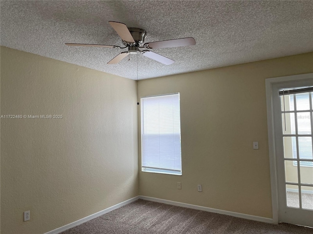 carpeted empty room featuring ceiling fan and a textured ceiling