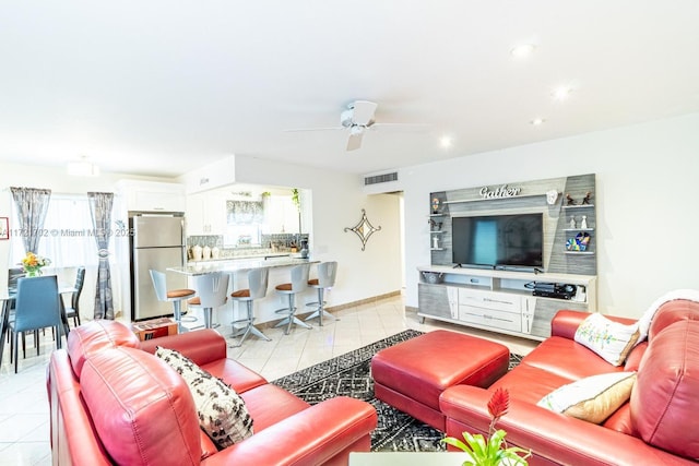 living room with ceiling fan and light tile patterned floors