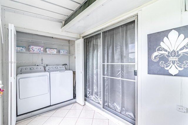 laundry area with washer and dryer and light tile patterned flooring