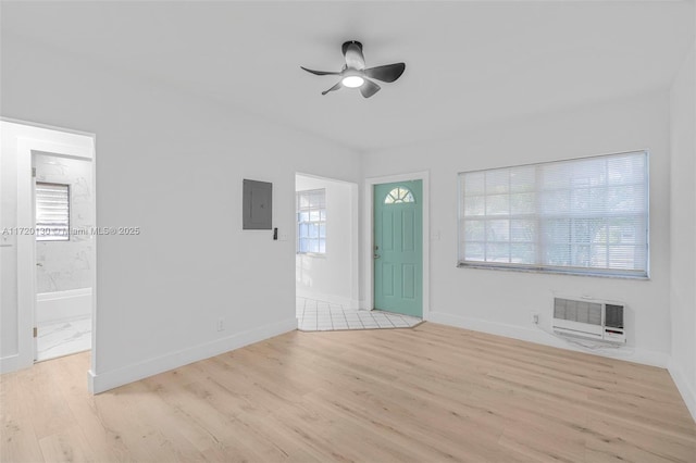 foyer entrance with ceiling fan, light hardwood / wood-style floors, electric panel, and heating unit