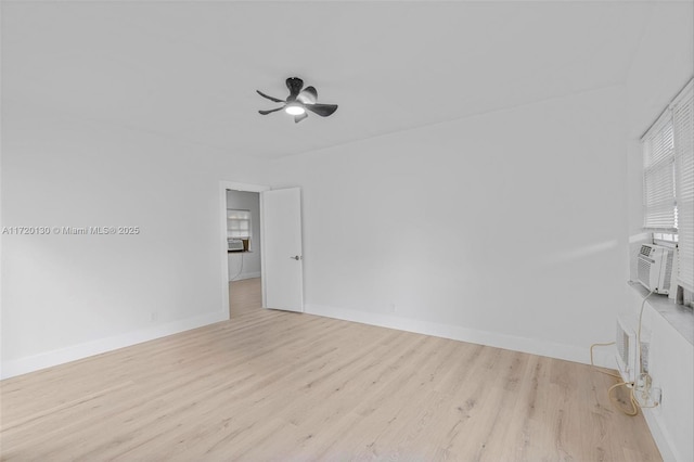 unfurnished room with ceiling fan, cooling unit, and light wood-type flooring