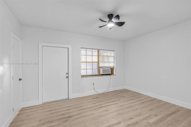 spare room with ceiling fan, cooling unit, and light hardwood / wood-style flooring