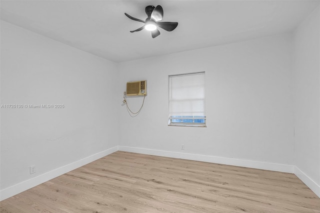 empty room featuring light wood-type flooring, an AC wall unit, and ceiling fan