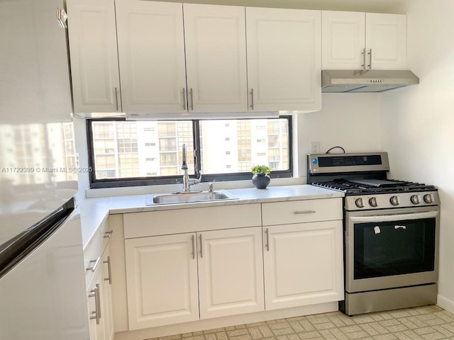 kitchen featuring white cabinets, appliances with stainless steel finishes, and sink