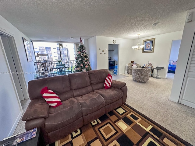 carpeted living room with a chandelier and a textured ceiling