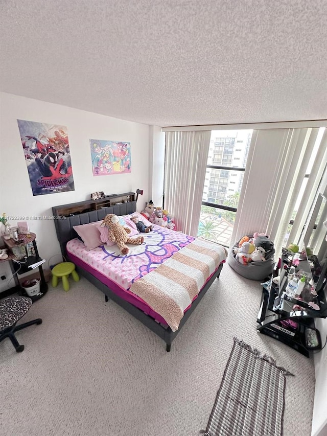 bedroom with carpet floors, expansive windows, and a textured ceiling