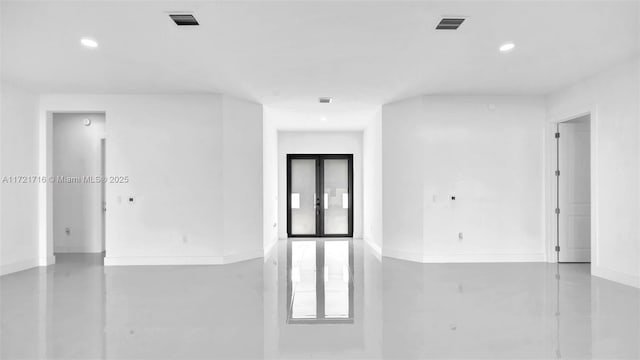 unfurnished room with concrete floors