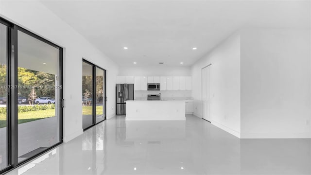 kitchen with a kitchen island, white cabinets, and appliances with stainless steel finishes