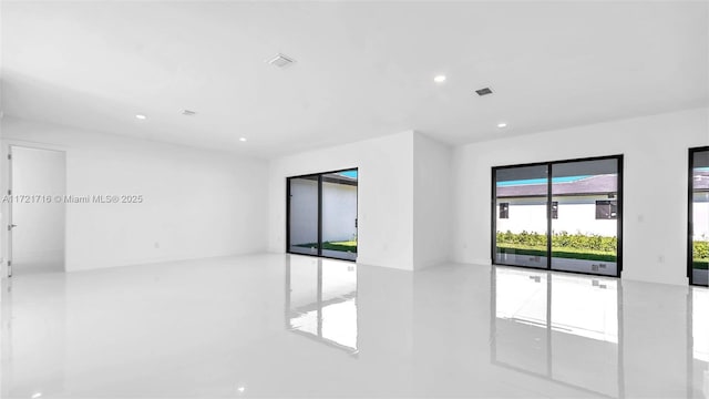 unfurnished room featuring concrete floors