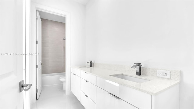 bathroom featuring tile patterned floors, vanity, and toilet