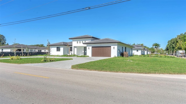 view of front facade featuring a garage and a front yard