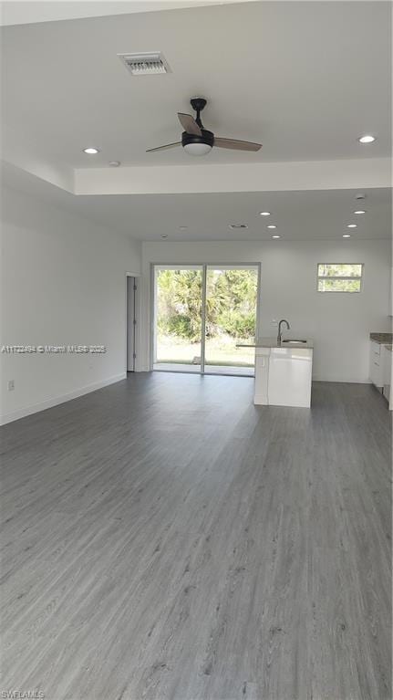 interior space with wood-type flooring and ceiling fan