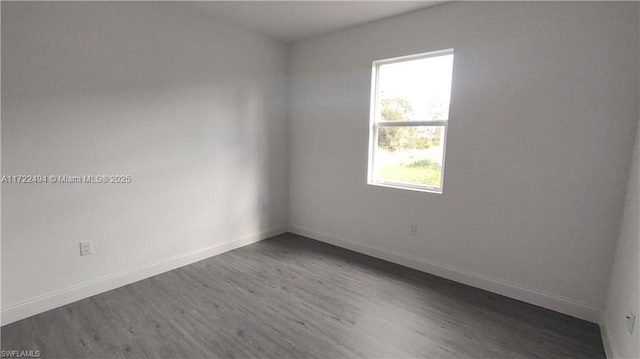 empty room with dark hardwood / wood-style floors