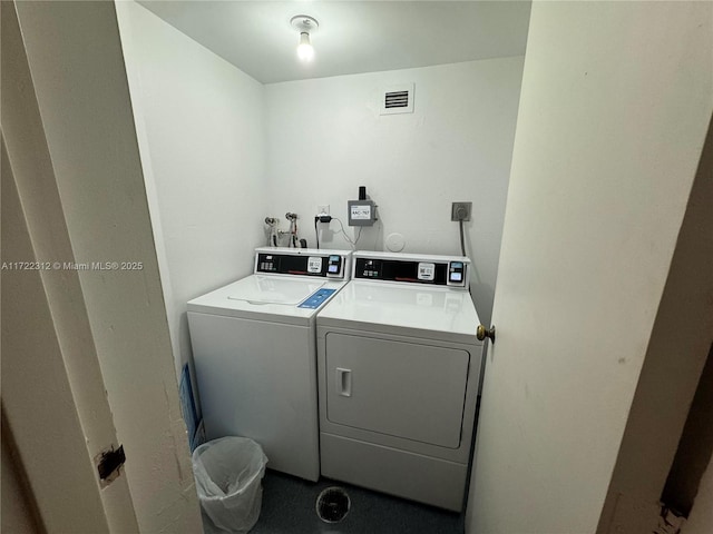 clothes washing area with separate washer and dryer