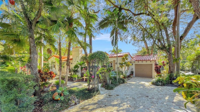 mediterranean / spanish-style house with a garage