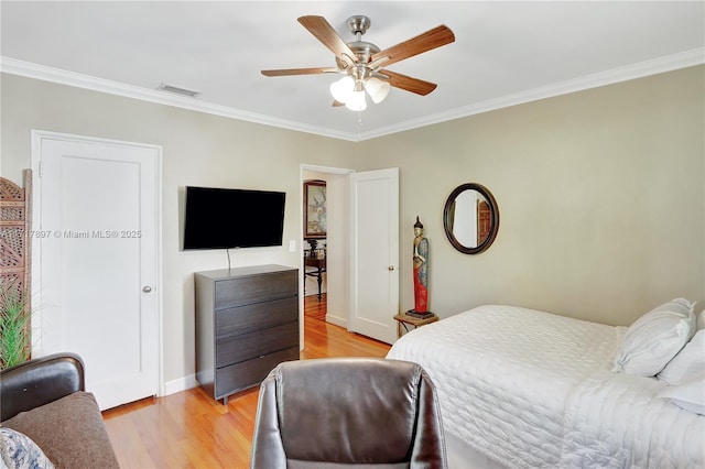 bedroom with ceiling fan, light hardwood / wood-style flooring, and ornamental molding