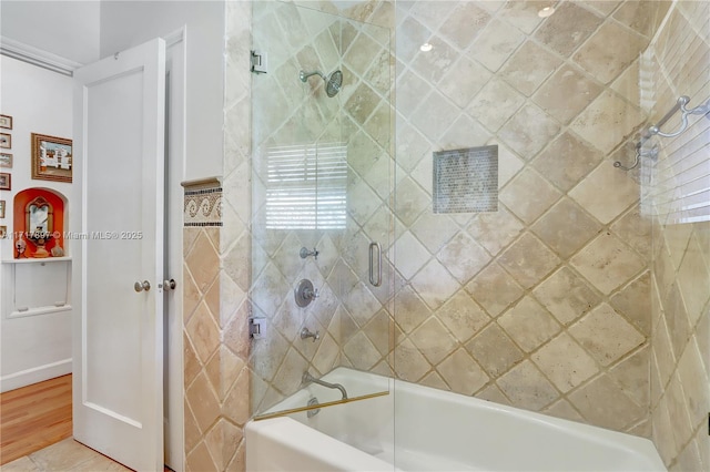 bathroom featuring tile patterned floors and enclosed tub / shower combo