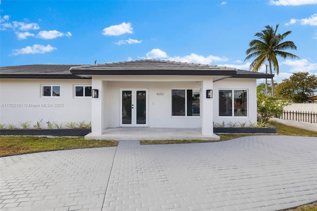 back of property featuring french doors