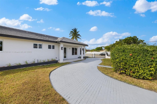 rear view of house with a yard