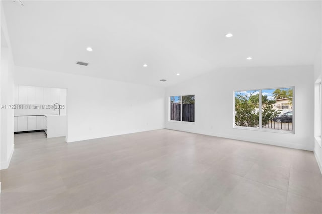 empty room with vaulted ceiling