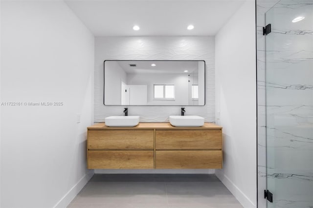 bathroom with a shower with door and vanity