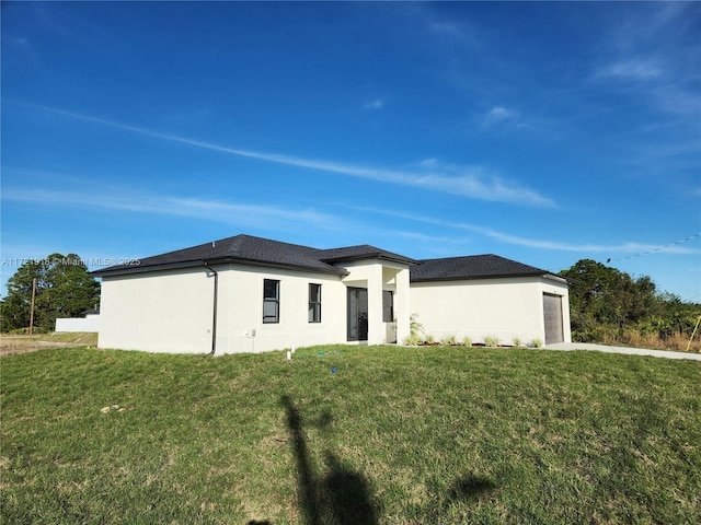 view of front of house with a front yard and a garage