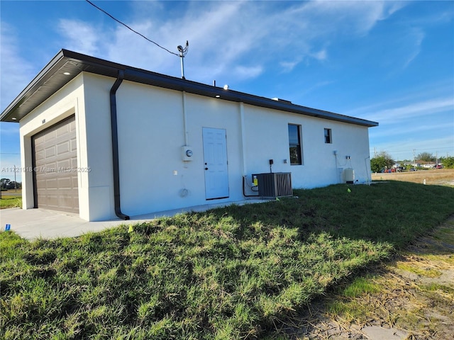 back of property featuring a yard and central AC unit