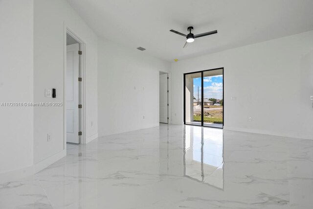 1608 Flora Ave S, Lehigh Acres, FL 33976 - unfurnished room with marble finish floor, baseboards, visible vents, and a ceiling fan