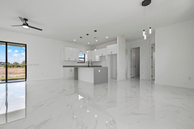 1608 Flora Ave S, Lehigh Acres, FL 33976 - unfurnished living room featuring recessed lighting, marble finish floor, a sink, and ceiling fan