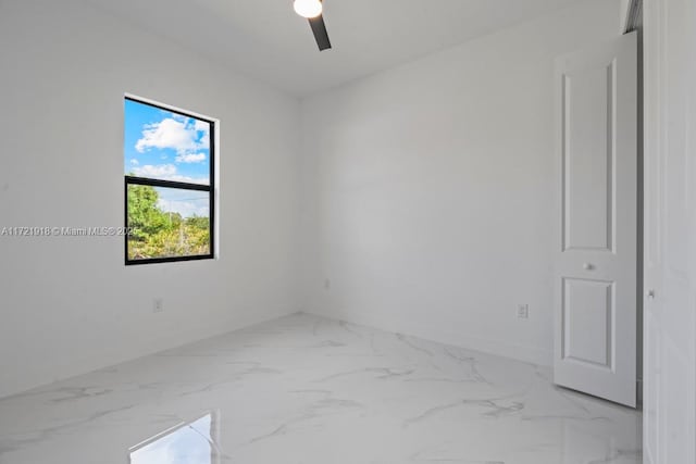 1608 Flora Ave S, Lehigh Acres, FL 33976 - spare room with marble finish floor, baseboards, and a ceiling fan