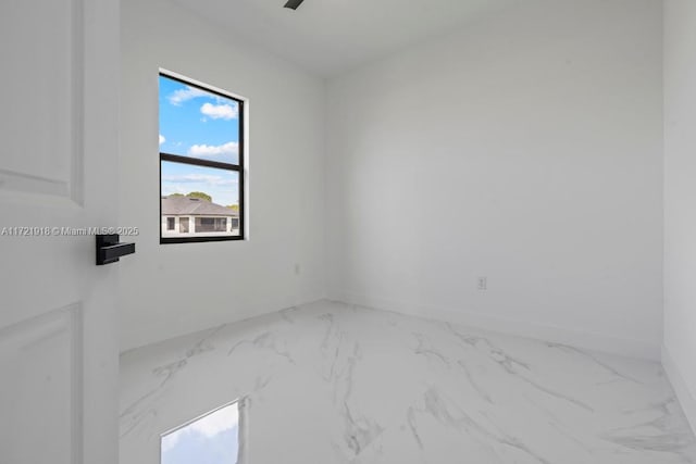 1608 Flora Ave S, Lehigh Acres, FL 33976 - spare room with marble finish floor, ceiling fan, and baseboards