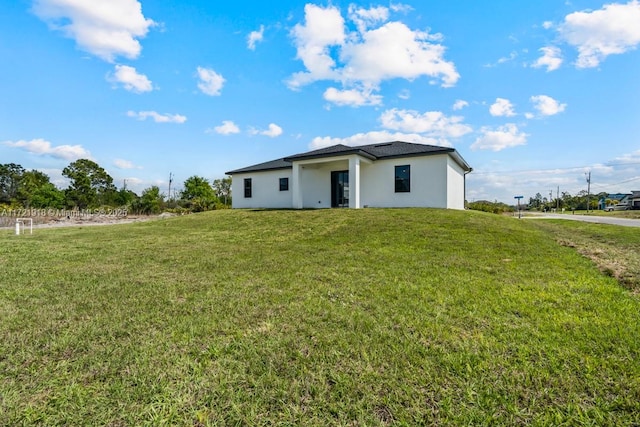 1608 Flora Ave S, Lehigh Acres, FL 33976 - view of front of property featuring a front yard and stucco siding