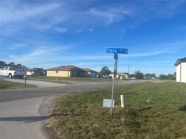 1608 Flora Ave S, Lehigh Acres, FL 33976 - view of street featuring traffic signs