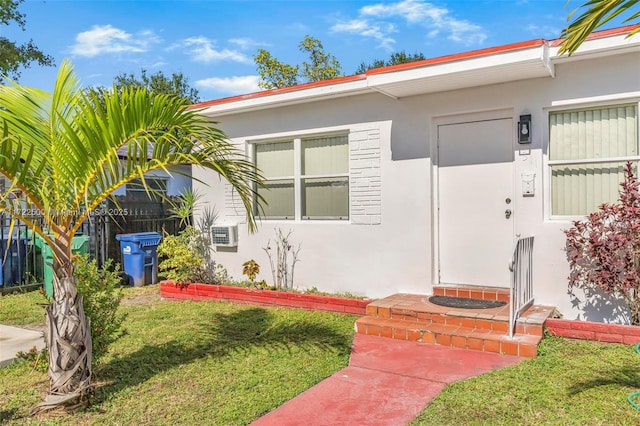 entrance to property featuring a yard