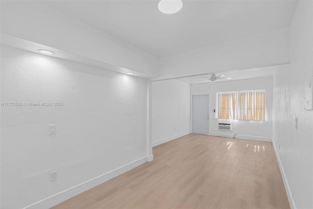 spare room with ceiling fan and light wood-type flooring