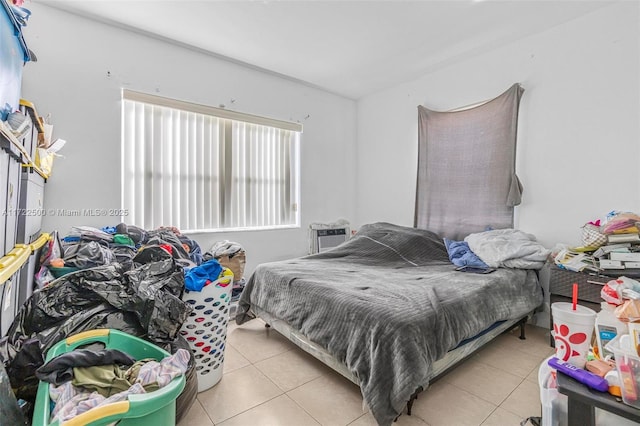 bedroom featuring a wall mounted air conditioner and light tile patterned floors