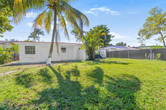 back of property featuring a lawn