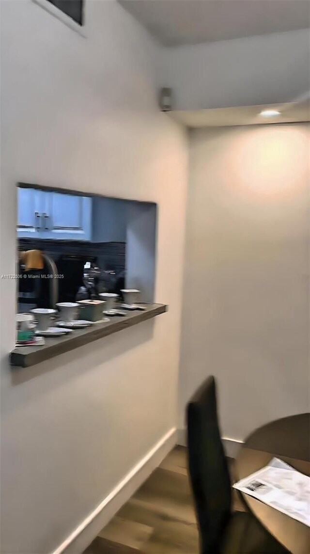 office area featuring baseboards and wood finished floors