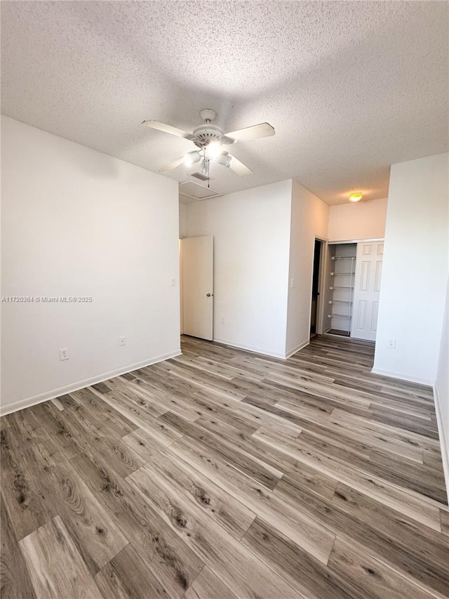 spare room featuring hardwood / wood-style floors, a textured ceiling, and ceiling fan