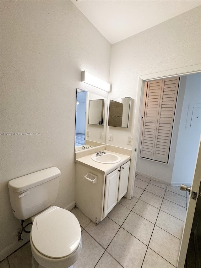 bathroom featuring tile patterned flooring, vanity, and toilet