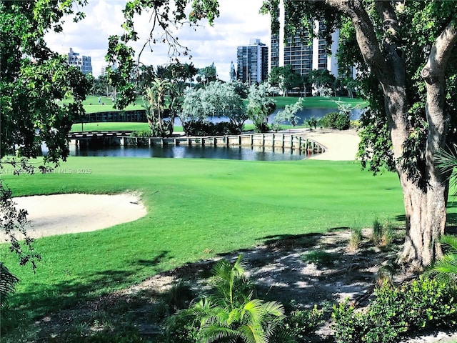 surrounding community with a yard and a water view