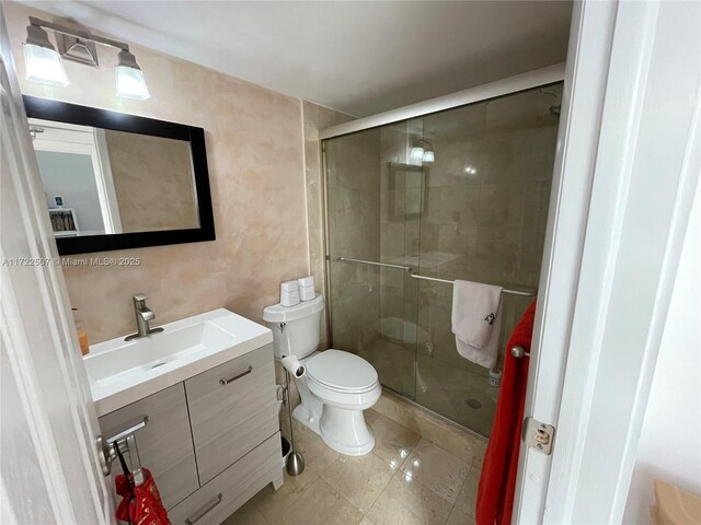 bathroom with vanity, toilet, and walk in shower