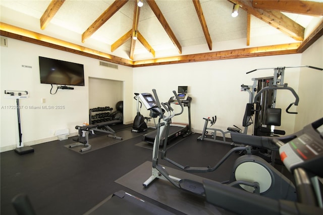 exercise room with beamed ceiling and high vaulted ceiling