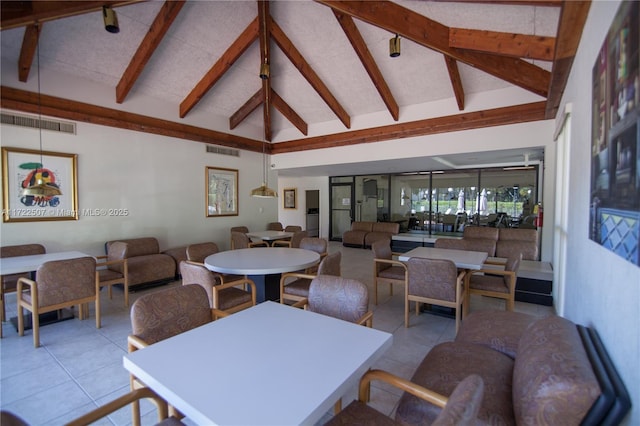 tiled dining space featuring beam ceiling and high vaulted ceiling