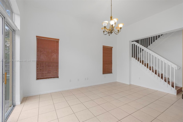 unfurnished room with light tile patterned floors and a chandelier