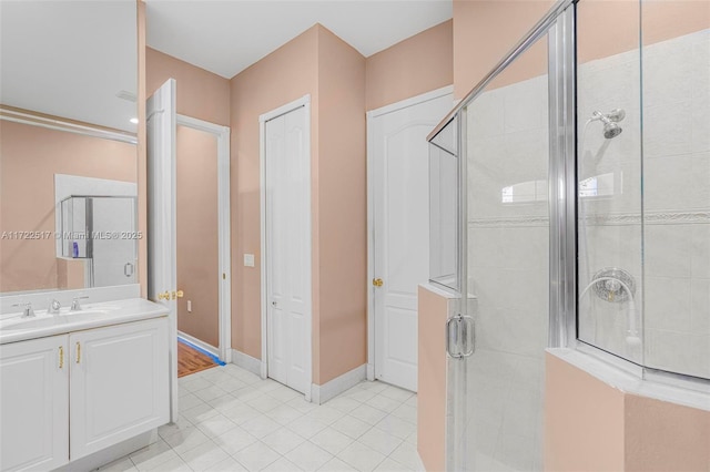 bathroom with tile patterned floors, vanity, and an enclosed shower