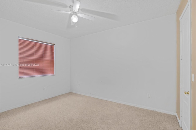 empty room with ceiling fan and light colored carpet