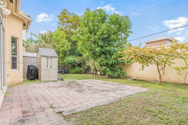 view of patio featuring a shed and area for grilling