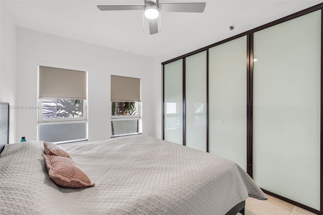 bedroom with ceiling fan and a closet