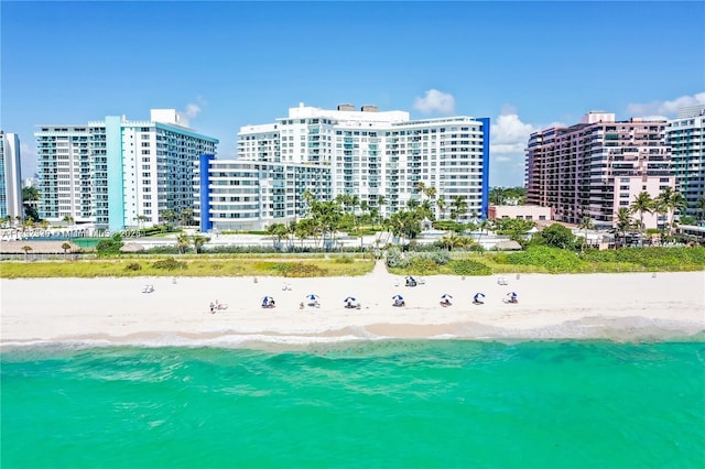 birds eye view of property featuring a water view and a beach view